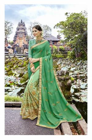 Have A Fresh And Elegant Look Everytime You Wear This Designer Saree, Grab This Saree In Green And Light Green Color Paired With Green Colored Blouse. This Saree Is Fabricated On Art Silk And Chiffon Paired With Art Silk fabricated Blouse. It Has Heavy Embroidery Making The Saree Attractive.