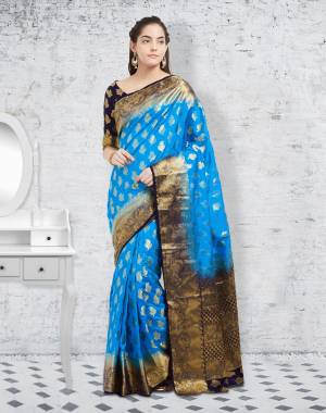 Grab This Pretty Saree In Blue Color Paired With Black Colored Blouse. This Saree And Blouse Are Fabricated On Banarasi Art Silk Beautified With Weave. It Is Light Weight And Durable.