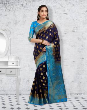 Enhance Your Personality Wearing This Silk Saree In Navy Blue Color Paired With Turquoise Blue Colored Blouse. This Saree And Blouse Are Fabricated On Banarsi Art Silk Beautified With Weave All Over.