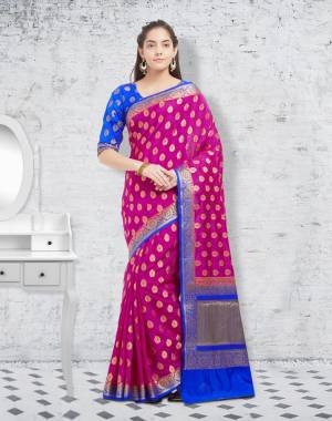 Add This Lovely Shade In Pink To Your Wardrobe With This Silk Saree In Magenta Pink color Paired With Contrasting Royal Blue Colored Blouse. This Saree and Blouse Are Fabricated On Banarasi Art Silk Beautified With Weave All Over.