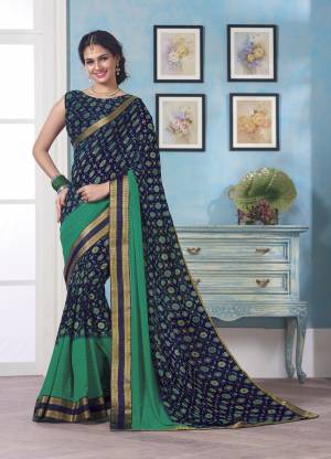 Small Pretty Floral Printed Saree Is Here In Navy Blue Color Paired With Navy Blue Colored Blouse. This Saree And Blouse Are Fabricated On Georgette Beautified With Prints And Lace Border. Buy Now.