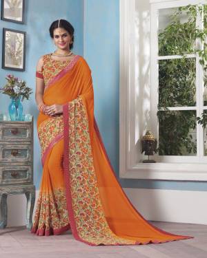 Shine Bright In This Orange Colored Saree Paired With Beige and Multi Colored Blouse. This Saree And bLouse Are Fabricated On Georgette Beautified With Small Floral Prints And Lace Border.