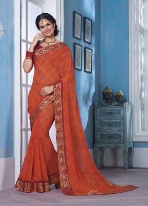 Bright Color Give A Perfect Summery Appeal To Any Outift, So Grab This Bright Orange Colored Saree Paired With Dark Pink Colored Blouse. This Saree And Blouse Are Fabricated On Georgette Beautified With Prints And Lace Border. 