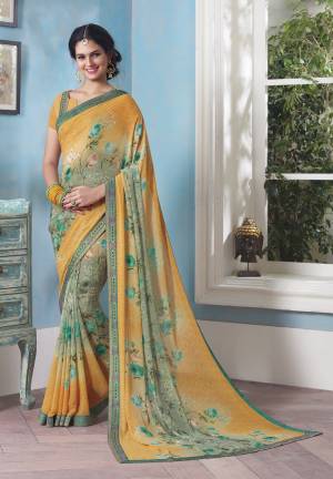Quite A Different Pattern Is Here With This Saree In Yellow And Mint Green Color Paired With Yellow Colored Blouse. This Saree And Blouse Are Fabricated On Georgette Beautified With Floral Prints.