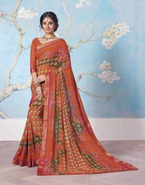 Bright Color Give A Perfect Summery Appeal To Any Outift, So Grab This Bright Orange Colored Saree Paired With Orange Colored Blouse. This Saree And Blouse Are Fabricated On Georgette Beautified With Prints And Lace Border. 
