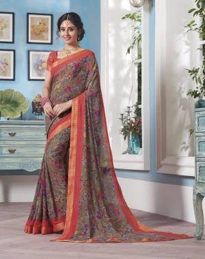 Flaunt Your Rich And Elegant Taste Wearing This Saree In Grey Color Paired With Contrasting Peach Colored Blouse. This Saree And Blouse are Fabricated On Georgette Beautified With Multi Colored Floral Prints All Over It.