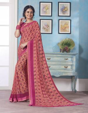 A Must Have Shade In Every Women Wardrobe Is Here With This Peach Colored Saree Paired With Contrasting Pink Colored Blouse. This Saree And Blouse Are Fabricated On Georgette Beautified With Small Floral Prints All Over It.
