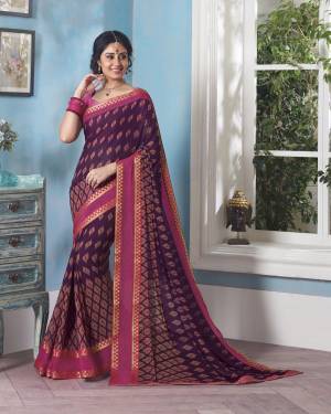 Dark And Lovely Shade Is Here With This Purple Colored Saree Paired With Contrasting Pink Colored Blouse, This Saree And Blouse Are Fabricated On Georgette Beautified With Small Floral Prints All Over It.