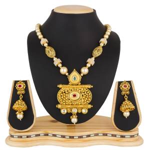 Grab This Elegant Looking Designer Heavy Necklace Set In Golden Color Beautified With White Colored Stone And Pearl Work. This Can Be Paired With Any Colored Traditional Attire. Buy Now.