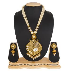 Grab This Elegant Looking Designer Heavy Necklace Set In Golden Color Beautified With White Colored Stone And Pearl Work. This Can Be Paired With Any Colored Traditional Attire. Buy Now.