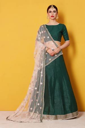 This set including Pine green round neck and half sleeve bodice encrusted with pearl lacework on neckline and sleeve line combined with flared kalidar lehenga with lace detailing on the hem side along with printed beige dupatta set.