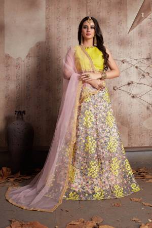 Featuring Pastel pink floral motif soft net lehenga . It is paired with yellow round neck,sleeveless art silk base blouse with matching Pastel pink dupatta set.