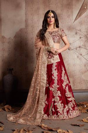 This set features a maroon semi velvet dori work lehenga choli set. It comes along with zari and dori lace work on dupatta and heavy embroidery butta on dupatta. Matching blouse with heavy dori work and zari work.