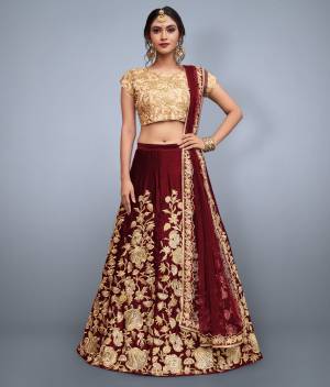 This set features maroon velvet dori work lehenga choli set. It comes along with cut work dupatta on net base. Matching Beige Colored blouse with heavy dori work.Looks completely heavy work.