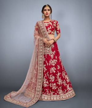 Featuring a round neck glitter sequin and dori work blouse and a Maroon color banglori silk lehenga with a matching Maroon shantoon interlining. The lehenga has a dori intricate design and matte glitter sequins work on it. Along with the set comes a matching beige shade on net dupatta embroidered with intricate sequins butis and heavy dori work lace cornered.