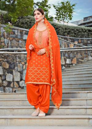 Orange Color Induces Perfect Summery appeal To Any outfit, So Grab This Suit In Orange Color Paired With Orange Colored Bottom And Dupatta. Its Top Is Fabricated On Soft Silk Paired With Santoon Bottom And Chiffon Dupatta. All Its Fabric Are Light Weight And Easy To carry All Day Long.
