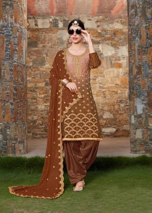 You Will Earn Lots Of Compliments Wearing This Designer Semi-Stitched Suit In Brown Color Paired With Brown Colored Bottom And Dupatta. Its Top Is Fabricated On Soft Silk Paired With Santoon Bottom And Chiffon Dupatta. It Has Heavy Embroidery Over The Top And Dupatta. Buy Now.