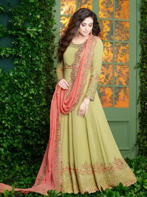 Add This Lovely Shade In Green To Your Wardrobe With This Designer Floor Length Suit In Pastel Green Color Paired With Pastel Green Colored Bottom And Dark Peach Colored Dupatta. Its Top Is Fabricated On Georgette Paired With Santoon Bottom And Georgette Dupatta. Its Top And Dupatta Is Beautified With Heavy Attractive Embroidery. 