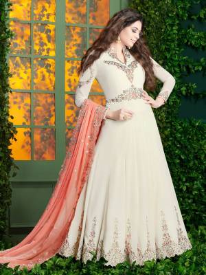 Simple And Elegant Looking, Designer Floor Length Suit Is Here In White Color Paired With White Colored Bottom And Peach Colored Dupatta. Its Top And Dupatta Are Fabricated On Georgette Paired With Santoon Bottom. Its Pretty Color And Embroidery Will Earn You Lots Of Compliments From Onlookers. Buy Now.