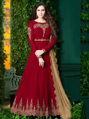 For A Rich And Royal Look, Grab This Designer Floor Length Suit In Maroon Color Paired With Maroon Colored Bottom And Beige Colored Dupatta. Its top And Dupatta Are Fabricated On Georgette Paired with santoon Bottom. This Suit Will Give A Royal Look Like Never Before.