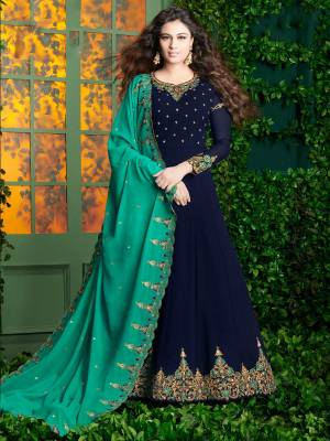 Enhance Your Personality Wearing this Designer Floor Length Suit In Navy Blue Color Paired With Navy Blue Colored Bottom And Turquoise Blue Colored Dupatta. Its Top And Dupatta are Georgette Based Fabric Paired With Santoon Bottom. 