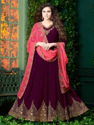 New And Unique Shade Is Here With This Designer Floor Length Suit In Wine Color Paired With Wine Colored Bottom And Contrasting Pink Colored Dupatta. Its Top And Dupatta Are Georgette Base Fabric Paired With Santoon Bottom. This Lovely Suit Will Definitely Earn You Lots Of Compliments From Onlookers.