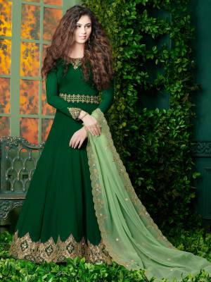 Celebrate This Festive Season Wearing This Designer Floor Length Suit In Dark Green Color Paired With Dark Green Colored Bottom and Light Green Colored Dupatta. Its Top Is Fabricated On Georgette Paired With Santoon Bottom And Georgette Dupatta. Buy This Suit Now.
