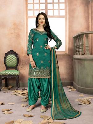Grab This Amazing Designer Salwar Suit In Green Color Paired With Green Colored Bottom And Dupatta. Its Top Is Fabricated On Art Silk Paired With Santoon Bottom And Net Dupatta. It IS Beautified with Jari Embroidery And Mirror Work. Buy Now.