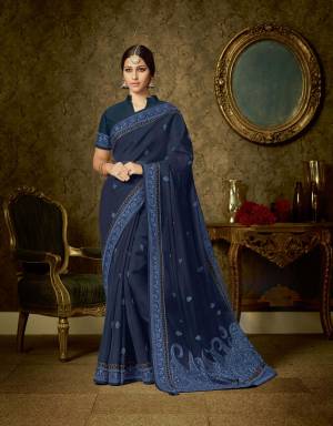 For women who like to look strong and majestic , this navy blue organza saree with tonal paisley embroidery will serve the purpose just right. Pair with statement jhumkis to add to extra panache. 
