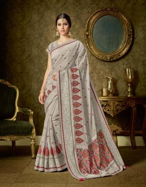 Wear this classic grey organza saree embellished with bright floral embroidery and look graceful. Let the world be stunned with your beauty. 
