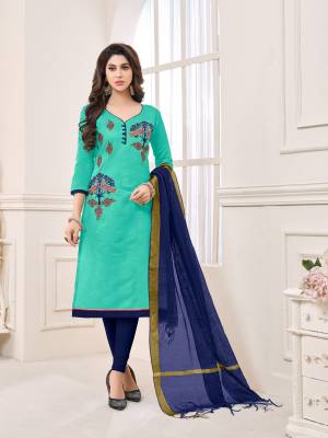 Go with this shades of blue with this dress material in aqua blue colored top paired with navy blue colored bottom and dupatta. Its top and bottom are fabricated cotton paired with chanderi dupatta. It has attractive peacock patterned thread work. 