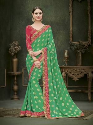 Celebrate This Festive Season Wearing This Designer Saree In Green Color Paired With Contrasting Dark Pink Colored Blouse. This Saree Is Fabricated On Jacquard Georgette Paired With Art Silk Fabricated Blouse. This Designer Saree Will earn You Lots Of Compliments From Onlookers.