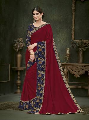 For A Royal Look, Grab This Elegant Looking Designer Saree In Maroon Color Paired With Contrasting Navy Blue Colored Blouse. This Saree Is Fabricated On Soft Silk Paired With Art Silk Fabricated Blouse. This Saree Is Beautified With Attractive Embroidered Lace Border And Blouse. 