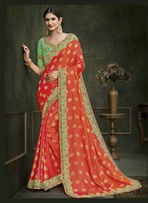 Get Ready for The Upcoming Festive Season With this Beautiful And Attractive Orange Colored Saree Paired With Contrasting Light Green Colored Blouse. This Saree IS Fabricated On Silk Jacquard Paired With Art Silk Fabricated Blouse. Its Embroidery Over The Blouse Is Making This Saree More Attractive. 