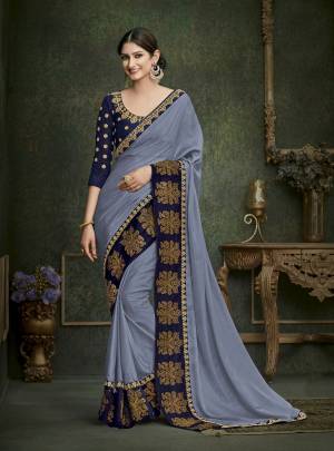 Flaunt Your Rich And Elegant Taste Wearing This Designer Saree In Grey Color Paired With Contrasting Navy Blue Colored Blouse. This Saree Is Fabricated On Crepe Silk Paired With Art Silk Fabricated Blouse. Its Rich Color And Embroidery Will Earn You Lots Of Compliments From Onlookers.