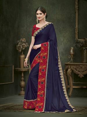 Grab This Beautiful Designer Saree In Navy Blue Color Paired with Contrasting Red Colored Blouse. This Saree Is Fabricated On Soft Silk Paired With Art Silk Fabricated Blouse. It Has Attractive Lace Border With Jari Embroidery Over The The Blouse With Stone Work. Buy Now.
