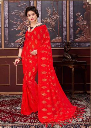 Adorn The Pretty Angelic Look Wearing This Attractive Saree In Red Color Paired With Navy Blue Colored Blouse. This Saree Is Fabricated On Fancy Net Paired With Jacquard silk Fabricated Blouse Beautified With Rubber Prints. Buy This Saree Now.