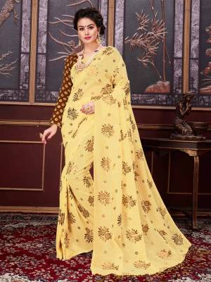 Get Ready for the upcoming festive season with this pretty saree in yellow color paired with contrasting brown colored blouse. Thi saree is fabricated on fancy net paired with jacquard slk fabricated blouse. Buy this saree now.