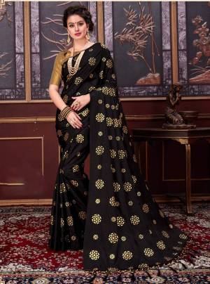 For a bold and beautiful look, grab this designer saree in black color paired with golden colored blouse. This saree is fabricated on fancy silk paired with jacquard silk fabricated blouse. This saree will earn you lots of compliments from onlookers. 
