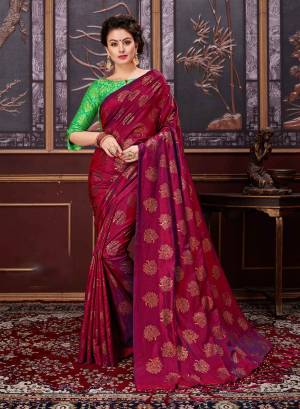 For a royal look, add this beautiful designer saree to your wardrobe in Maroon color paired with contrasting light green colored blouse. This saree is fabricated on fancy silk paired with jacquard silk fabricated blouse.  Both the fabrics ensures superb comfort all day long.