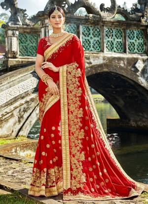 Adorn the pretty anhelic look wearing this georgette based sare in red color paired with red colored blouse. Its pretty blouse is fabricated on net and art silk. It has heavy jari and thread embroidery with stone work. Buy this designer saree now.