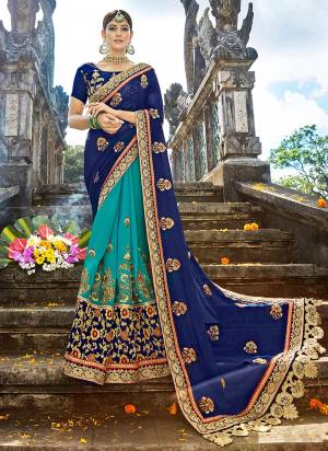 Go with the shades of blue wearing this designer saree in blue and turquoise blue color paired with blue colored blouse. This saree is fabricated on georgette and art silk paired with art silk fabricated blouse. It has heavy attractive embroidery over the saree. buy now.