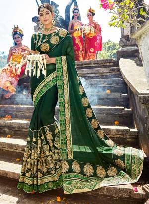 Celebrate this festive season wearing this designer saree in dark green color paired with dark green colored blouse. This saree is fabricated on chiffon silk paired with art silk fabricated blouse. Inspite of heavy embroidery this saree enusres superb comfort throughout the gala. buy now.