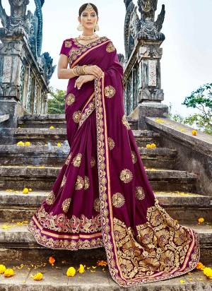 Bright and visually appealing color is here with this designer saree in purple color paired with purple colored blouse. This attractive looking saree and blouse are art silk based fabric beautified with heavy embroidery.