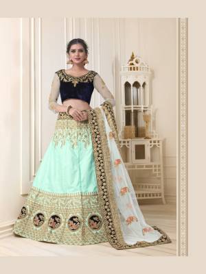 Here are beautiful shades of blue with this heavy designer lehenga choli in navy blue colored blouse paired with aqua blue colored lehenga and off-white colored dupatta. Its blouse is velvet based fabric paired with art silk lehenga and net dupatta. All Its fabrics esnures superb comfort all day long.