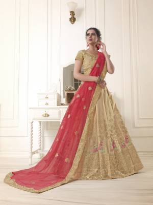 Flaunt your rich and elegant taste with this simple but heavy designer lehenga choli in beige color paired with red colored dupatta. Its blouse and lehenga are fabricated on art silk paired with net fabricated dupatta. Buy now.