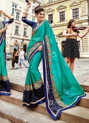 Add This Very Pretty Designer Saree To Your Wardrobe In Turquoise Blue Color Paired With Dark Blue Colored Blouse. This Saree Is Fabricated On Silk Georgette Paired With Art Silk Fabricated Blouse. It Has Attractive Embroidered Lace Border. Buy Now.