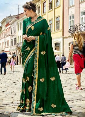 You Will Definitely Earn Lots Of Compliments Wearing This Designer Saree In Dark Green Color Paired With Dark Green Colored Blouse. This Saree IS Fabricated On Silk Georgette Paired With Art Silk Fabricated Blouse. It Is Embroidered Motifs All Over It.