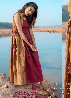 Grab This Beautiful Maxi Dress In Maroon and Beige Color In Sleeveless pattern with adjustable waist tie up and hanging laces are clubbed with hand-made pompom hangings.?khadi is a fabric that will keep you cool in summers and warm in winters