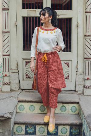 Here Is A Lovely Baggy Pants Pair In White Colored Top Paired With Rust Colored Baggy Pants. This Pair Is Khadi Cotton Based Fabric And Available In Sizes. Buy This Lovely Pair Now.